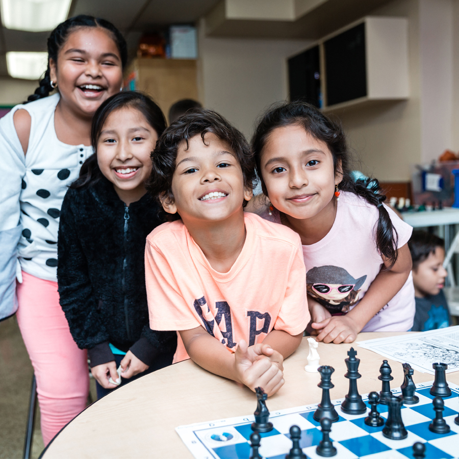 Boy playing chess at school