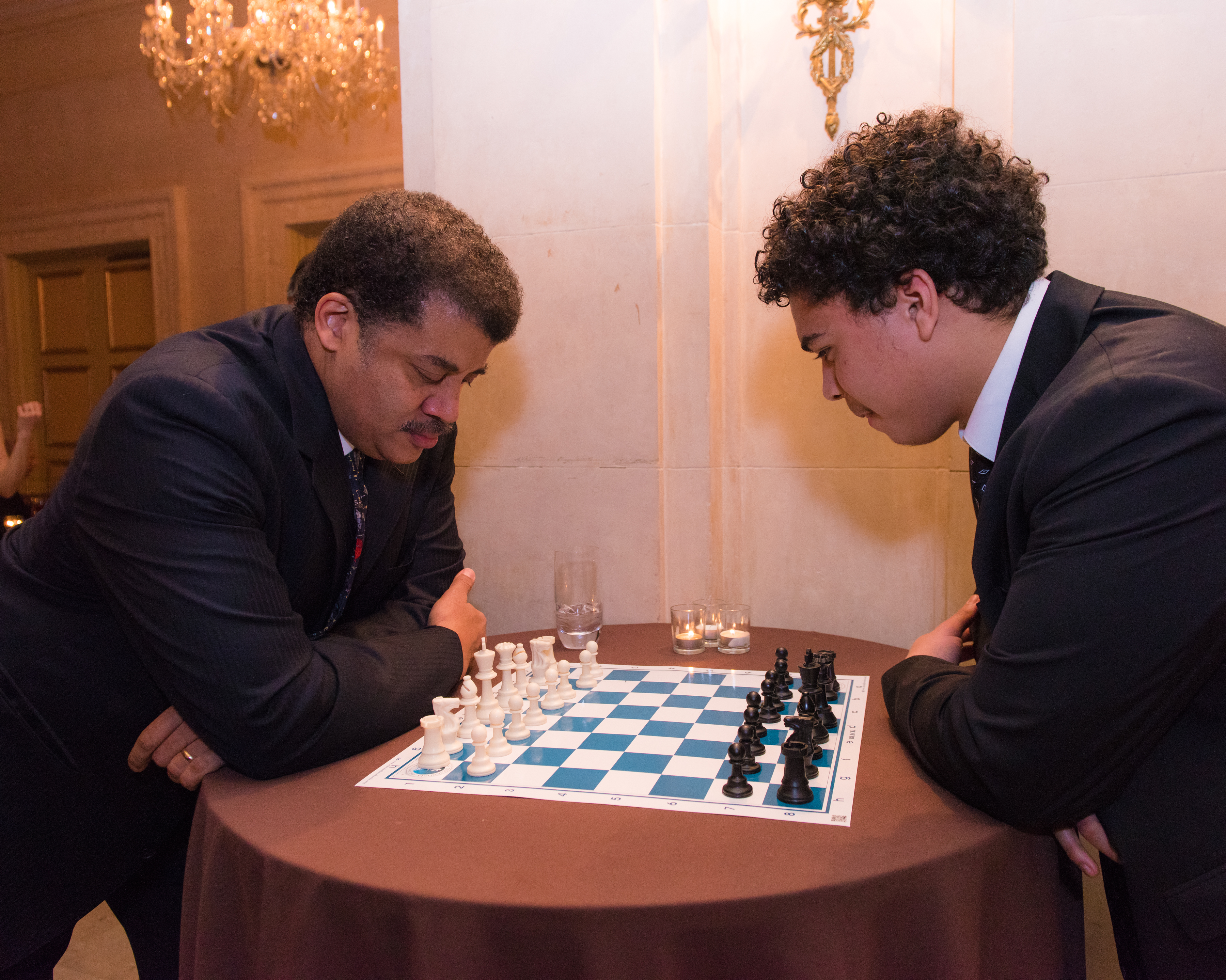 Dr. Neil deGrasse Tyson challenges College Bound student, John Paul Garcia, to a chess game during cocktails.